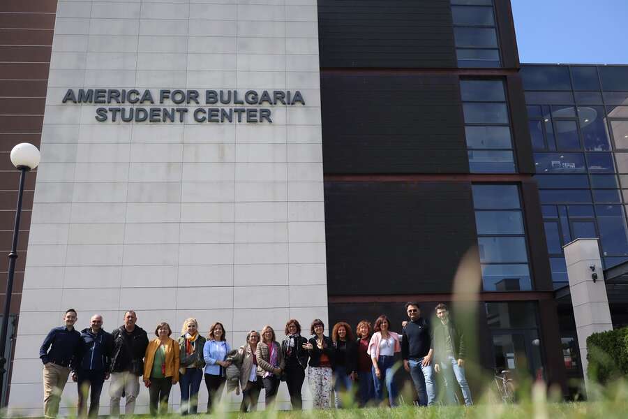 A group of people in front of the building of the American University of Bulgaria.